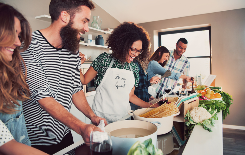 group engaged in cooking class at kitchen counter