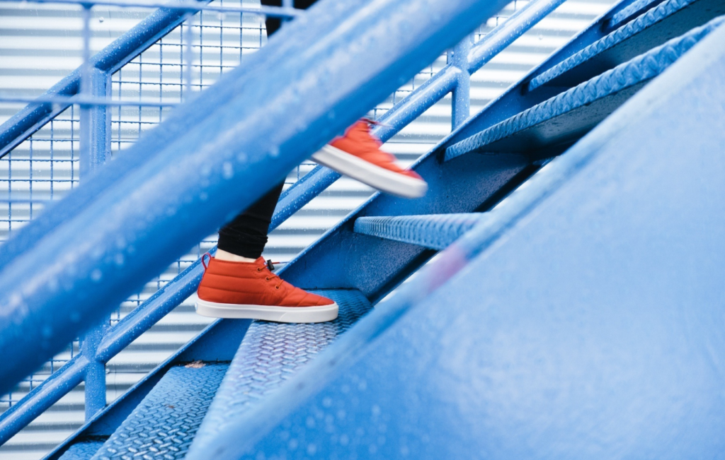 feet in sneakers ascending staircase